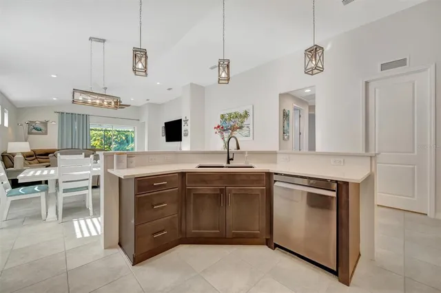 a living room with furniture a flat screen tv and a table