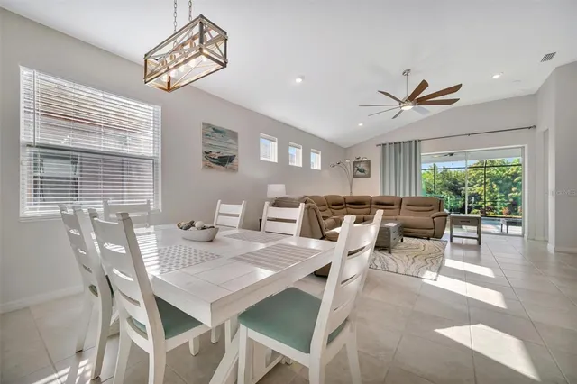 a living room with furniture a window and a dining table