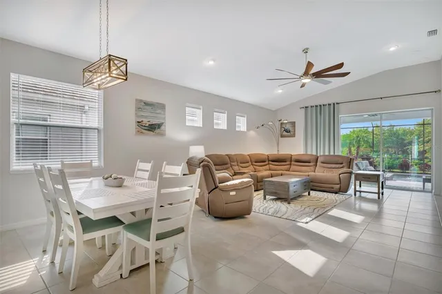 a kitchen with stainless steel appliances kitchen island granite countertop a sink refrigerator and cabinets