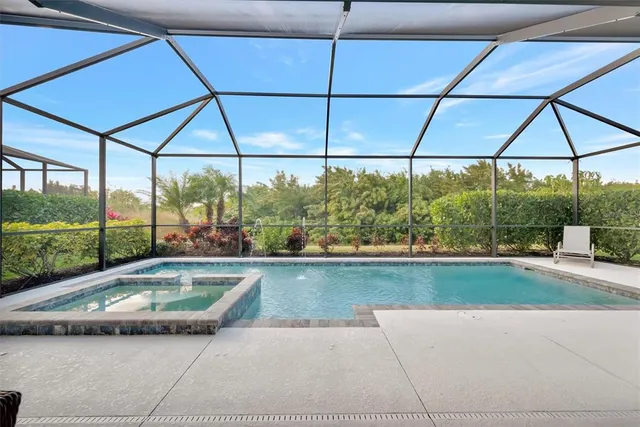 a swimming pool with outdoor seating and yard