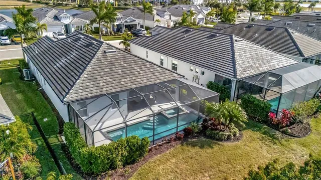 an aerial view of a house with a yard and sitting area