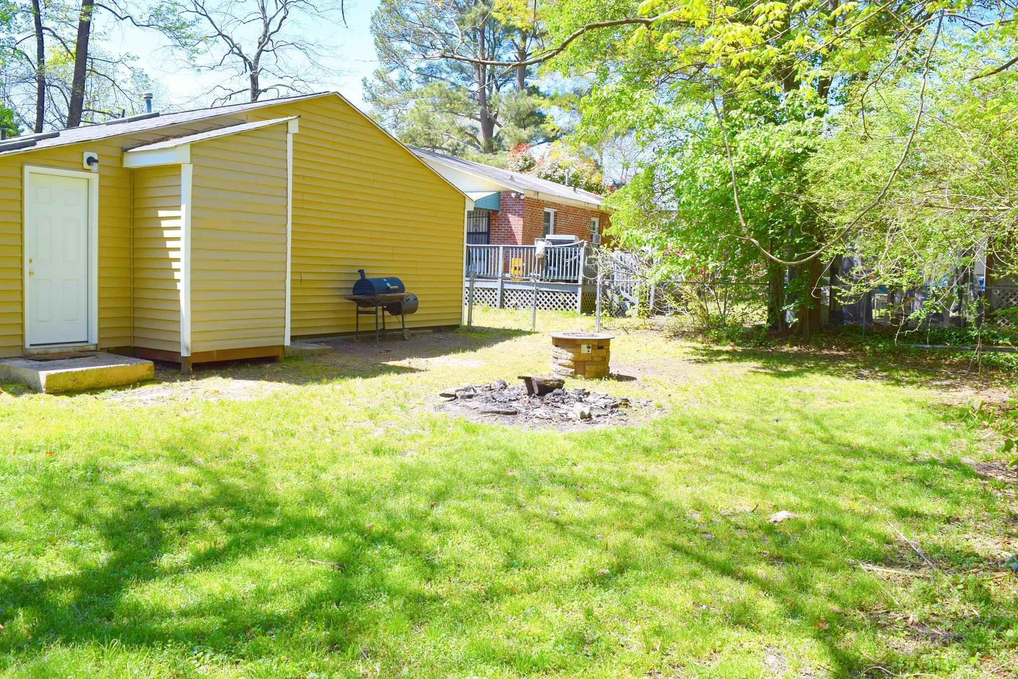 2912 Okelly Street Raleigh, NC 27607 - Photo 5 of 11 a view of a backyard with table and chairs and a barbeque