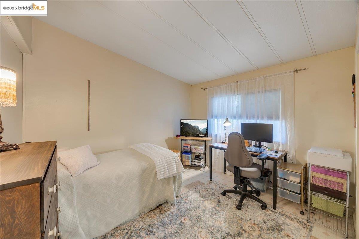 14192 Tuolumne Road, Unit 67 Sonora, CA 95370 - Photo 13 of 26 a bed room with a bed and a chair