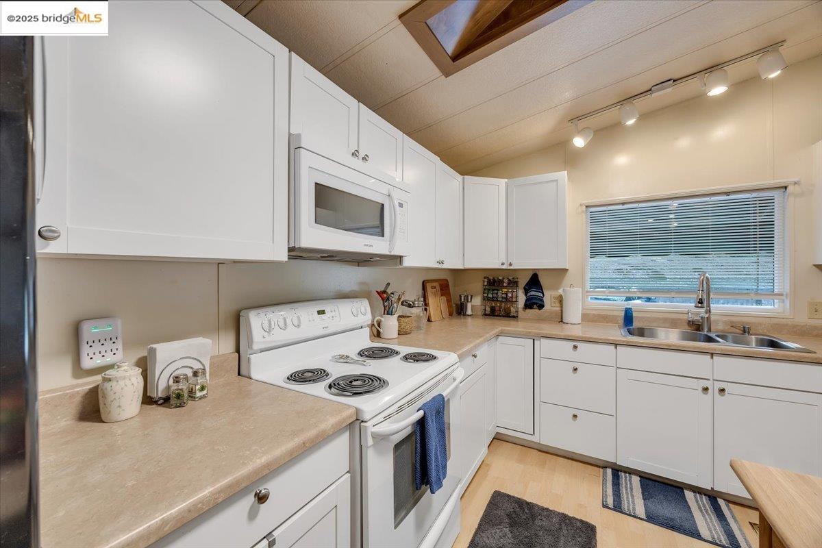 14192 Tuolumne Road, Unit 67 Sonora, CA 95370 - Photo 2 of 26 a kitchen with a sink a stove and cabinets