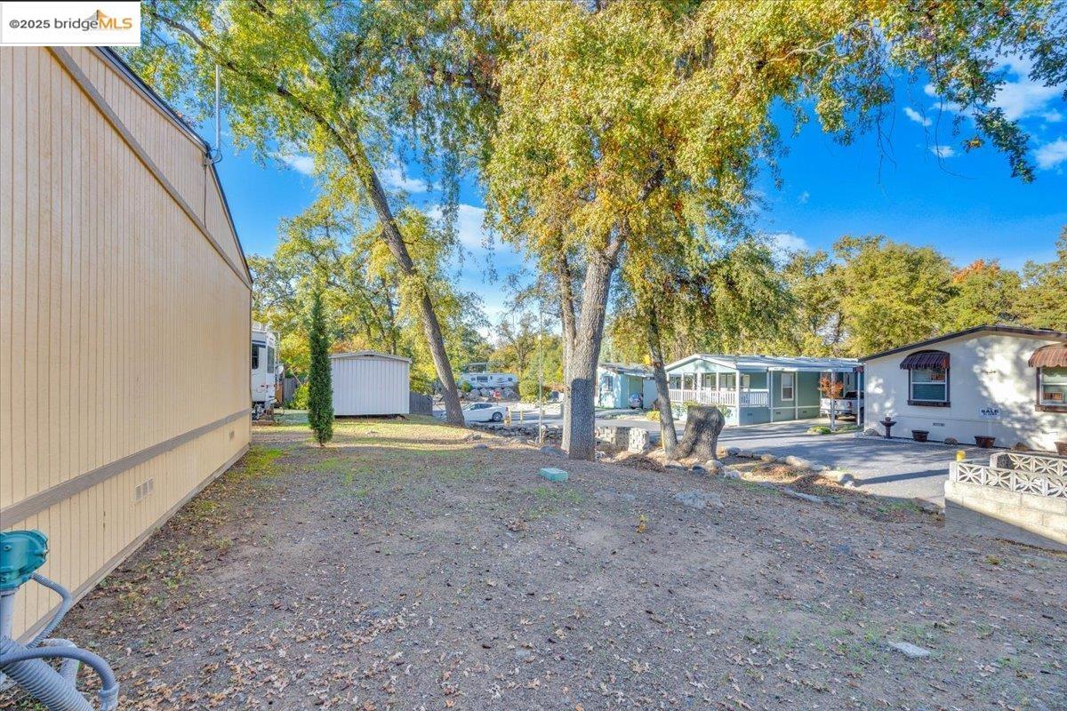 14192 Tuolumne Road, Unit 67 Sonora, CA 95370 - Photo 7 of 26 a view of a house with backyard and trees