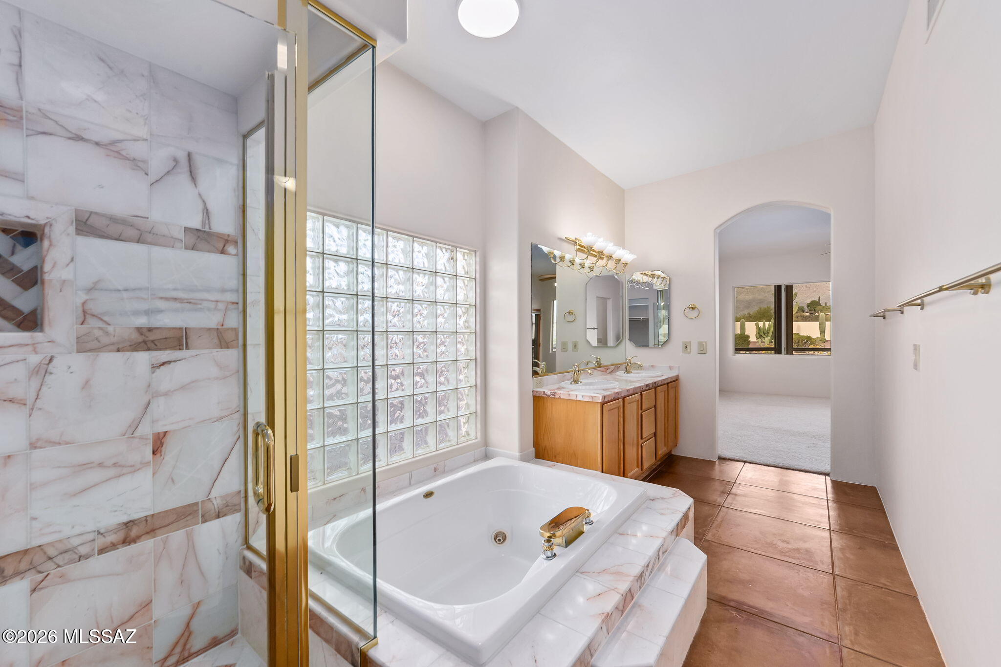 3655 North Harrison Road Tucson, AZ 85749 - Photo 26 of 51 a bathroom with a tub sink and mirror