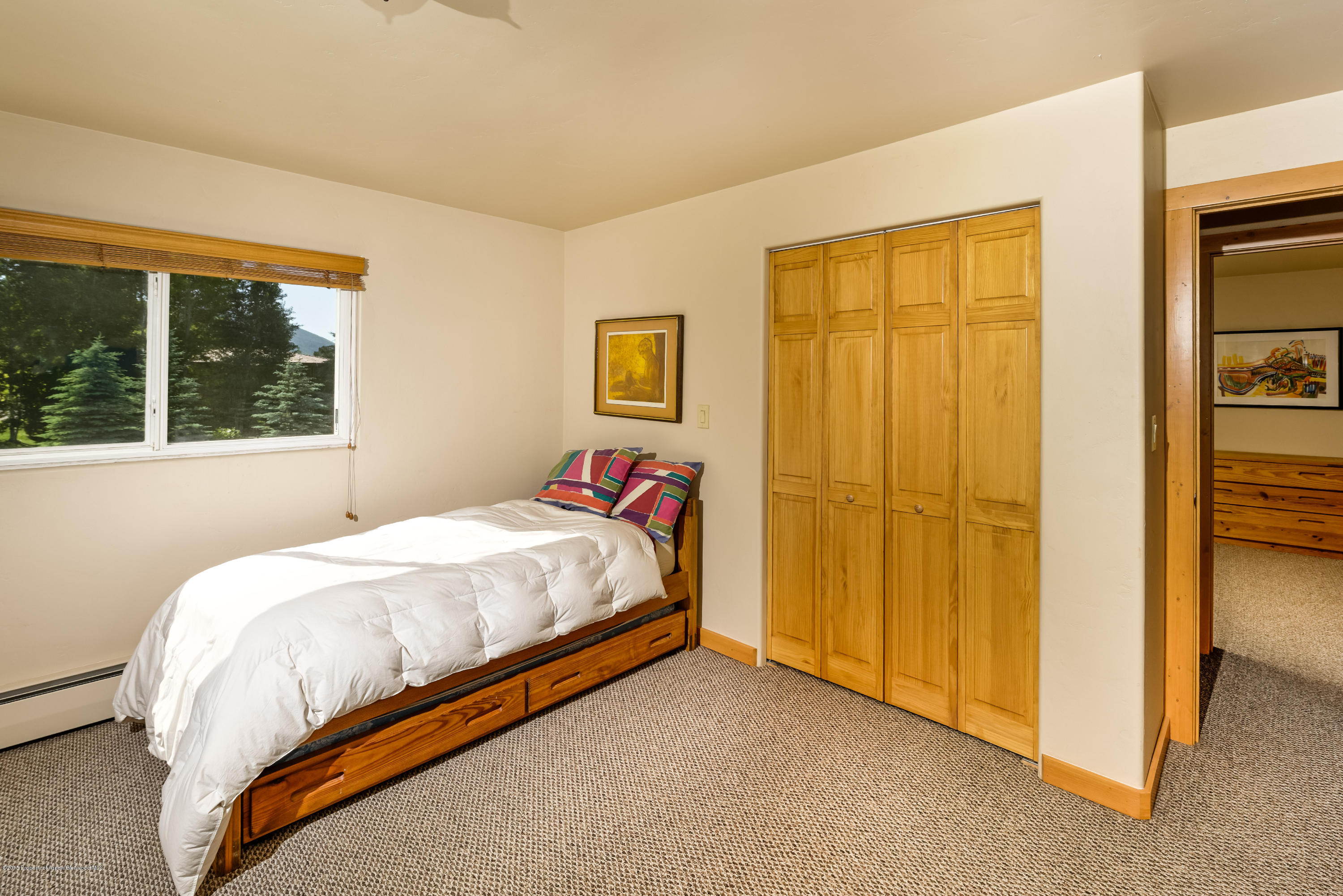 336 Holland Hills Road Basalt, CO 81621 - Photo 7 of 17 a bed sitting in a bedroom next to a window