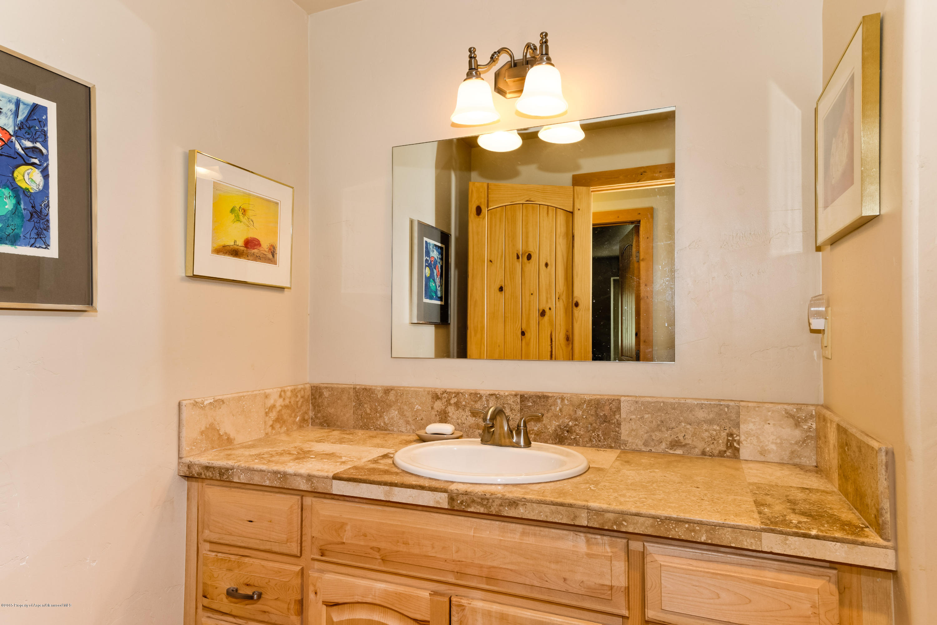 336 Holland Hills Road Basalt, CO 81621 - Photo 10 of 17 a bathroom with a granite countertop sink and a mirror