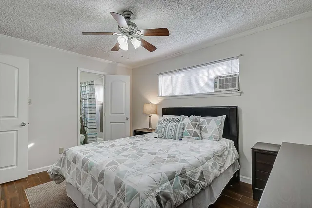 a bedroom with a large bed and a chandelier