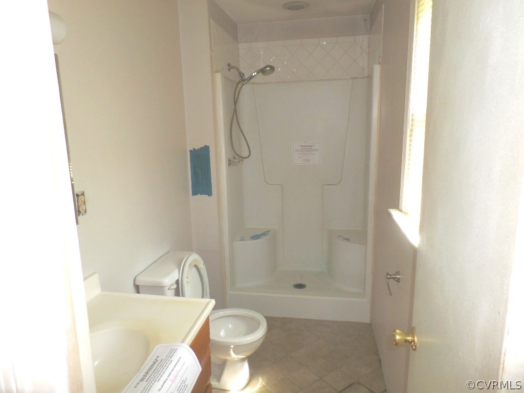 19002 Beaver Dam Road Beaverdam, VA 23015 - Photo 10 of 19 a bathroom with a granite countertop sink toilet and shower