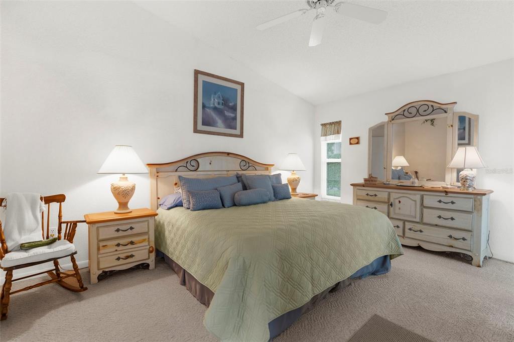 9426 Mississippi Run Weeki Wachee, FL 34613 - Photo 11 of 31 a bedroom with a bed and a chandelier