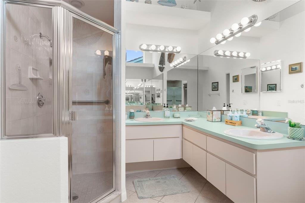9426 Mississippi Run Weeki Wachee, FL 34613 - Photo 14 of 31 a spacious bathroom with a granite countertop sink mirror and shower