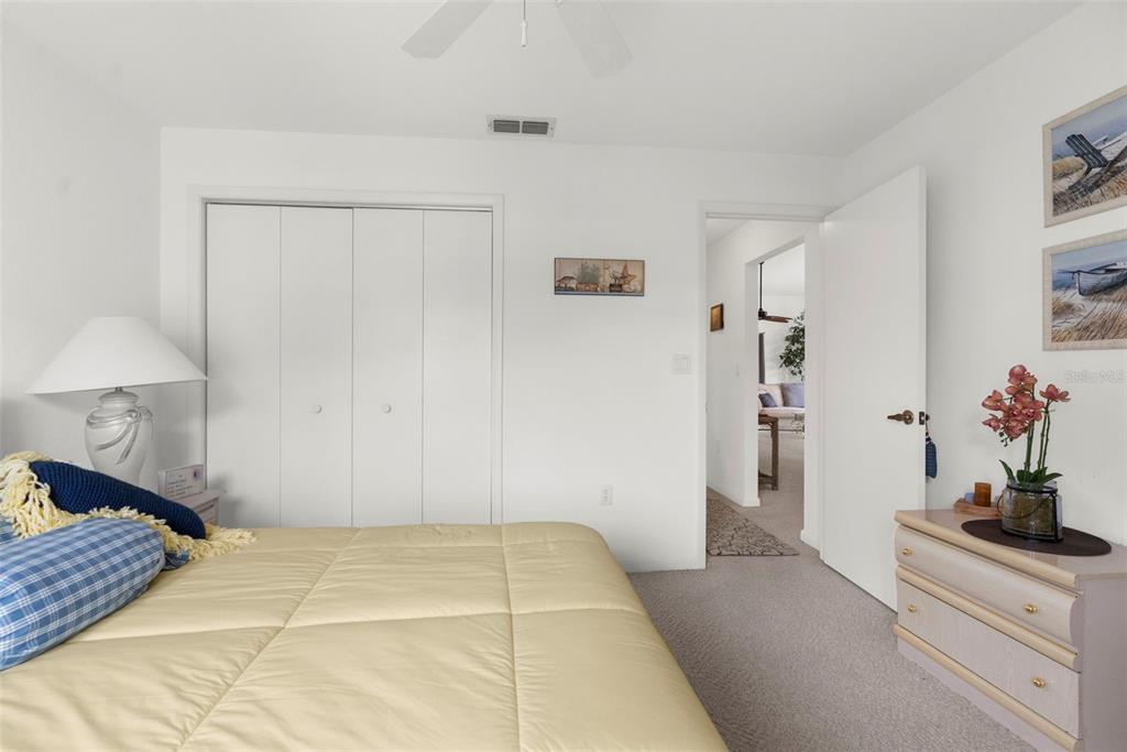 9426 Mississippi Run Weeki Wachee, FL 34613 - Photo 17 of 31 a bedroom with a bed and a potted plant on the dresser