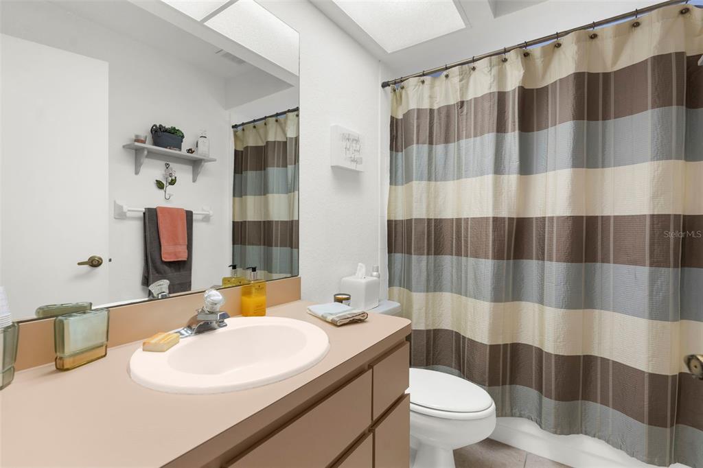 9426 Mississippi Run Weeki Wachee, FL 34613 - Photo 18 of 31 a bathroom with a sink and a mirror