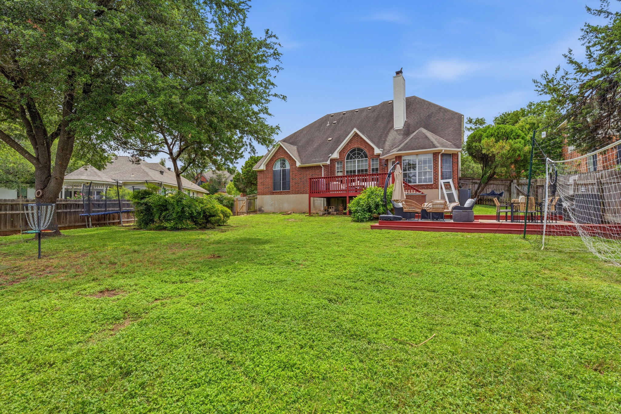 8317 Pommel Drive Austin, TX 78759 - Photo 25 of 26 A spacious yard provides ample room for outdoor activities, complementing the home's rear deck for entertainment.