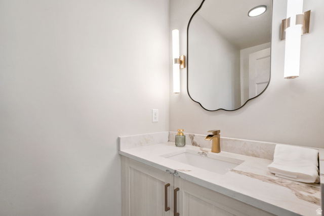10646 North Reflection Ridge Hideout, UT 84036 - Photo 12 of 43 White vanity with light wood-finish cabinetry, a white countertop with brown veining, and a rectangular undermount sink