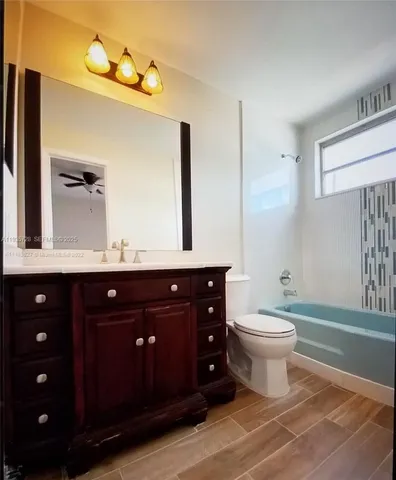 a bathroom with a toilet a sink and mirror