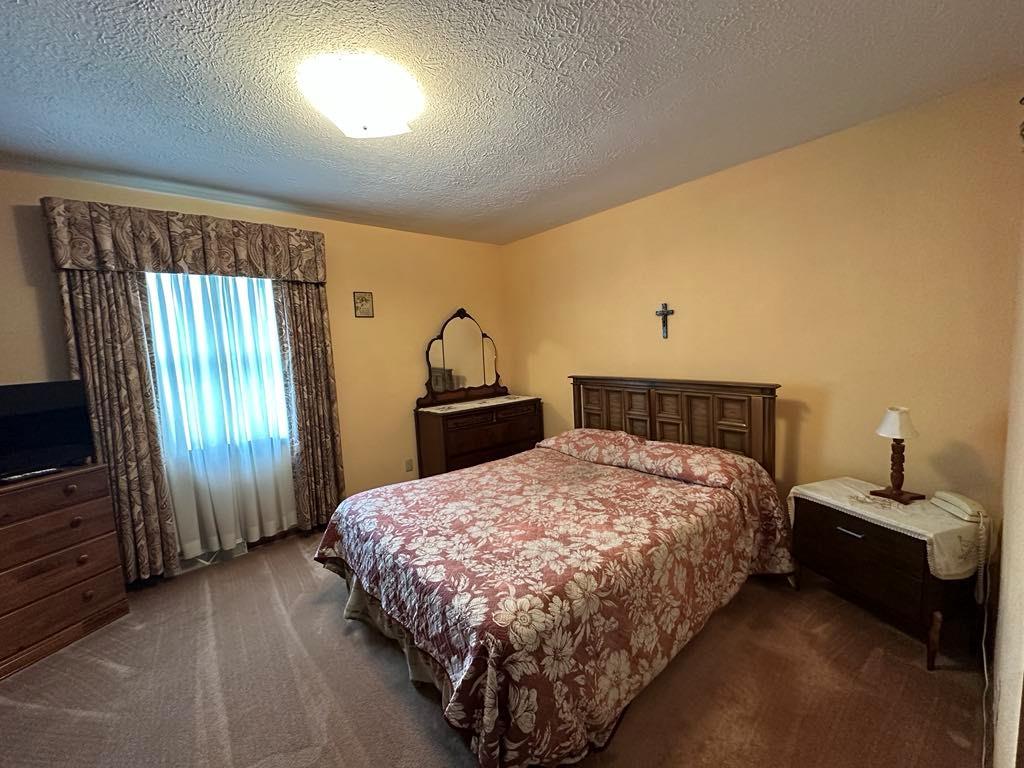 861 Chicora Road Chicora, PA 16025 - Photo 11 of 30 a bedroom with a bed and a television