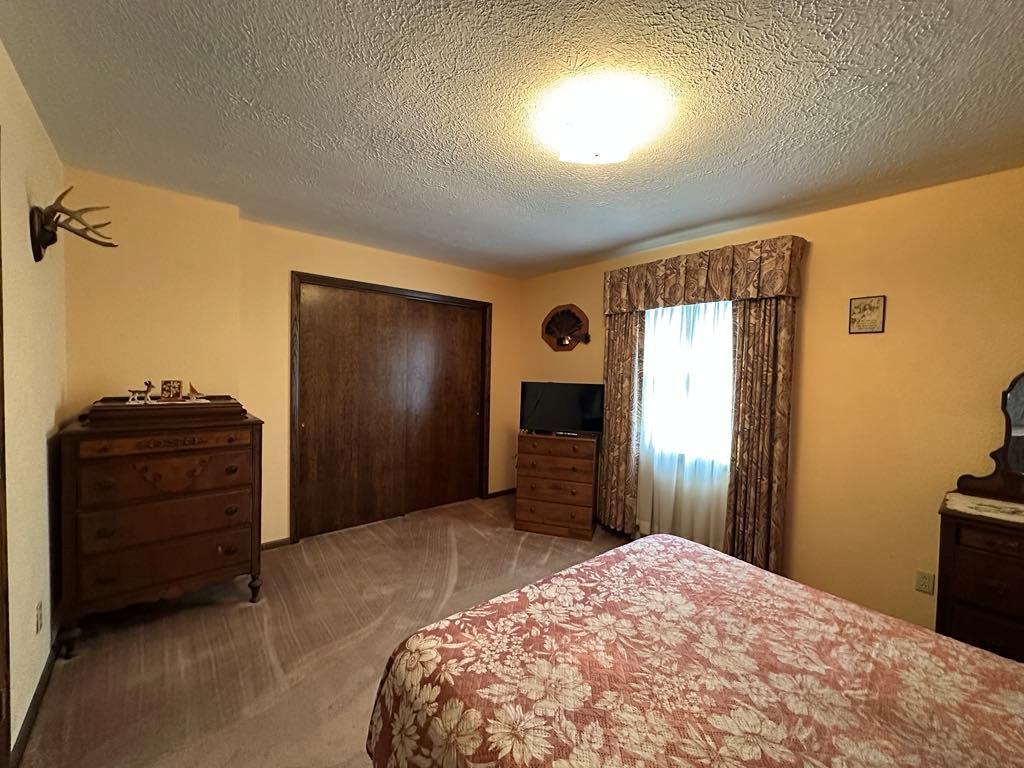 861 Chicora Road Chicora, PA 16025 - Photo 12 of 30 a bedroom with a bed and a television