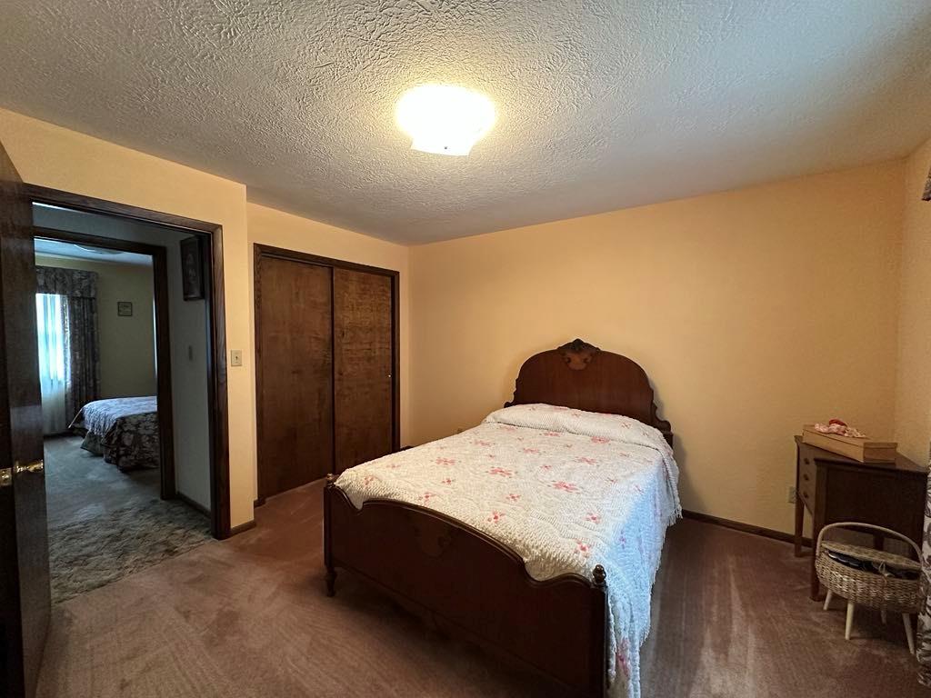 861 Chicora Road Chicora, PA 16025 - Photo 14 of 30 a bedroom with a bed and a table in it