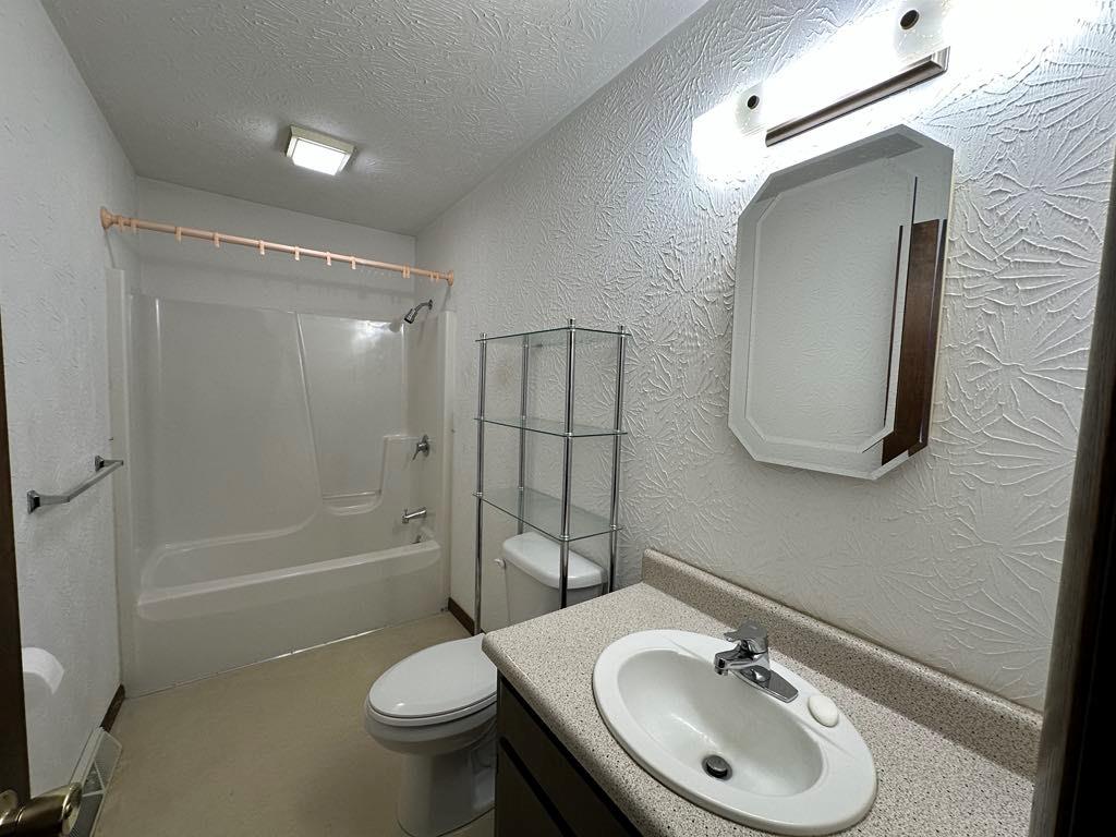 861 Chicora Road Chicora, PA 16025 - Photo 19 of 30 a bathroom with a sink toilet mirror and shower