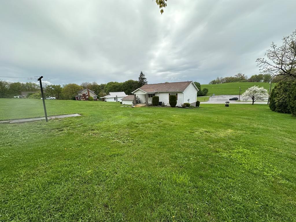 861 Chicora Road Chicora, PA 16025 - Photo 28 of 30 a view of a big yard with potted plants and large trees
