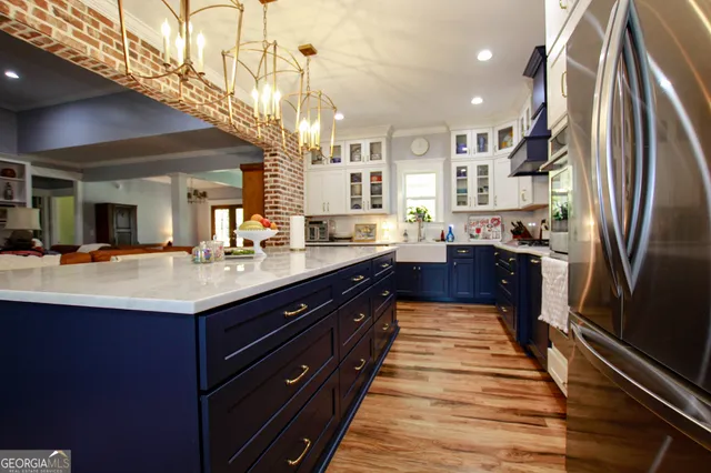 a large kitchen with stainless steel appliances granite countertop plenty wooden cabinets