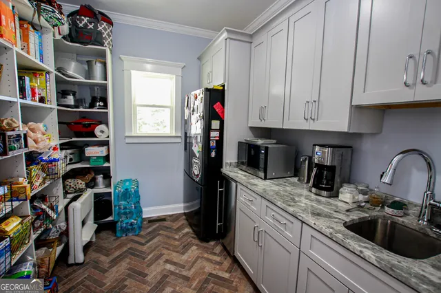 a living room with furniture a chandelier and a fireplace