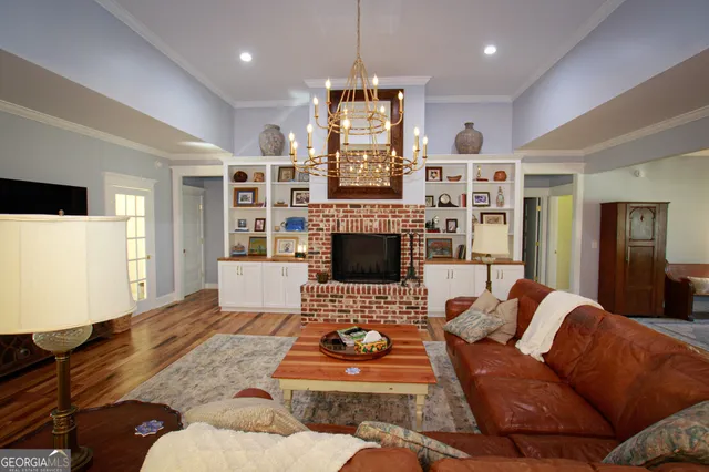 a living room with patio furniture and a potted plant
