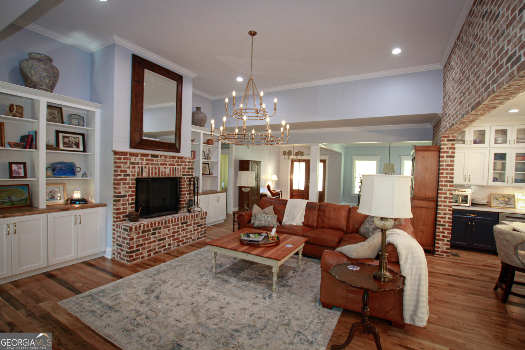 1010 Rock Road Perry, GA 31069 - Photo 20 of 58 a living room with furniture a fireplace and a chandelier