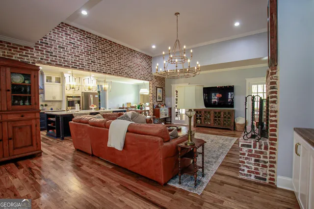 a living room with stainless steel appliances kitchen island granite countertop furniture and a kitchen view