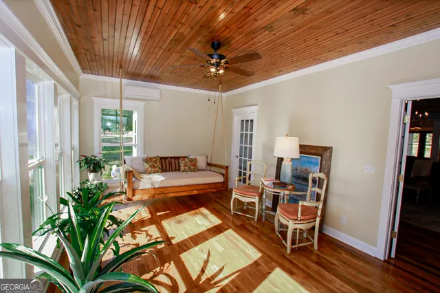 a living room with fireplace furniture and a chandelier