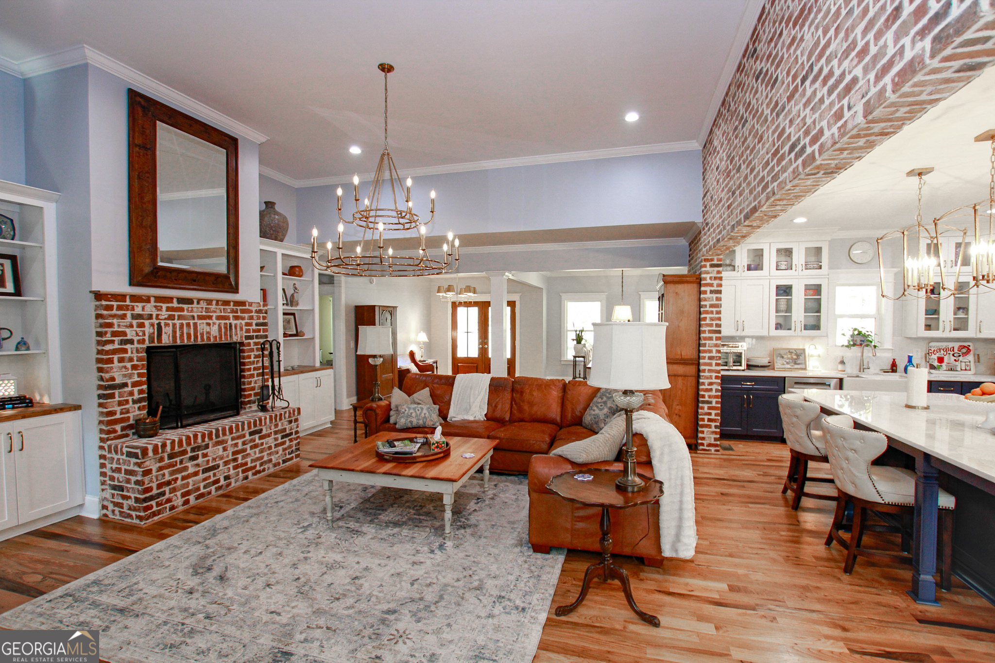 1010 Rock Road Perry, GA 31069 - Photo 23 of 58 a living room with fireplace furniture and a chandelier