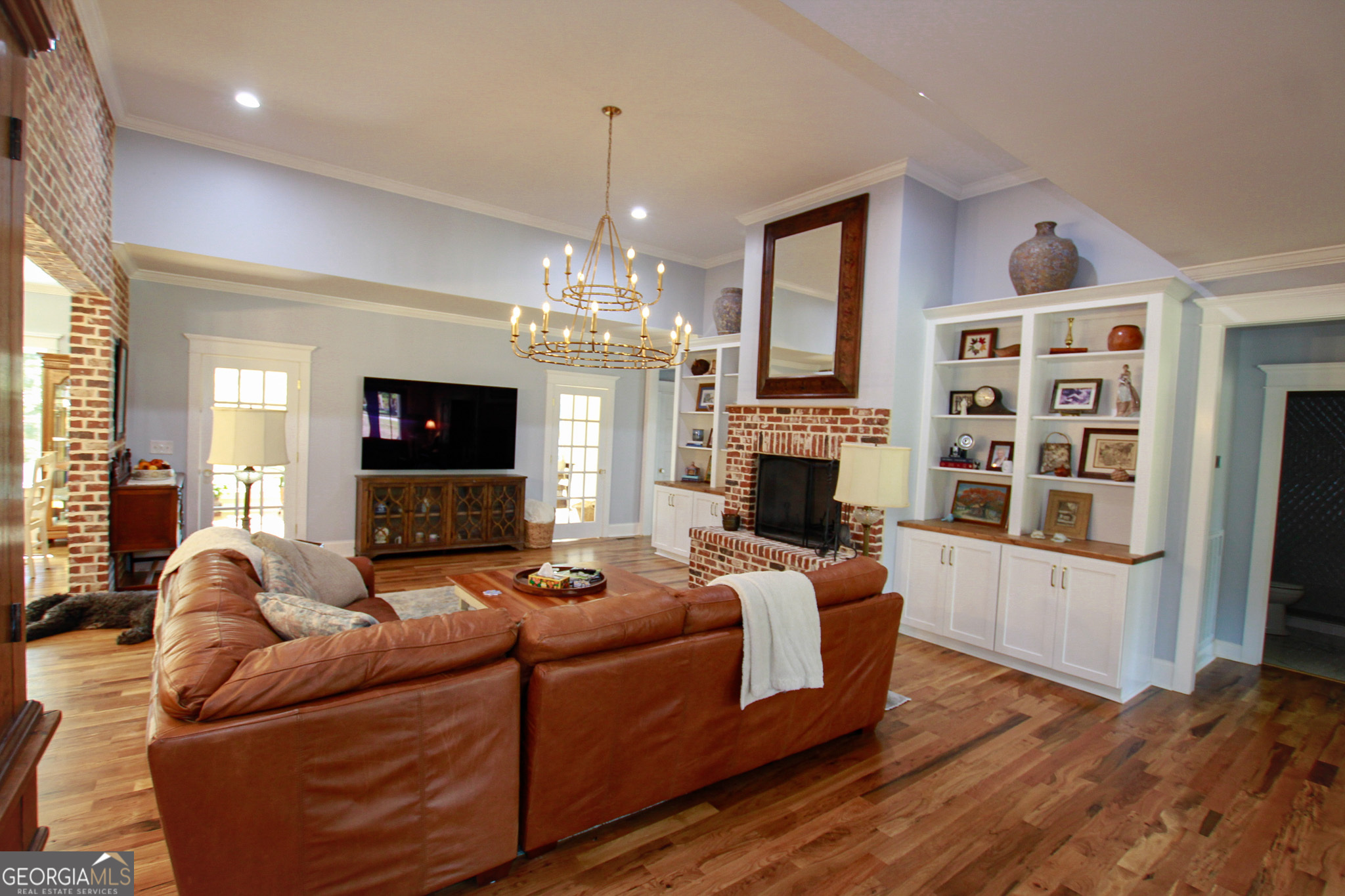 1010 Rock Road Perry, GA 31069 - Photo 30 of 58 a living room with furniture a fireplace and a chandelier