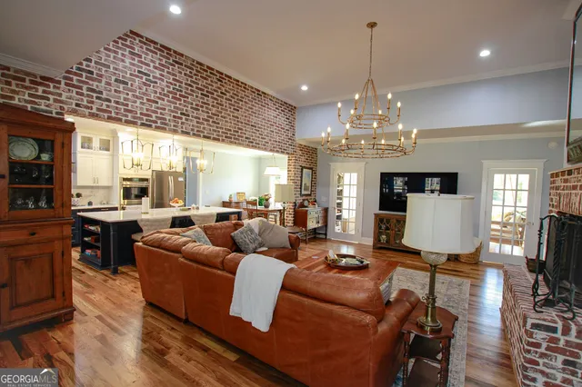 a living room with furniture a chandelier and a chandelier