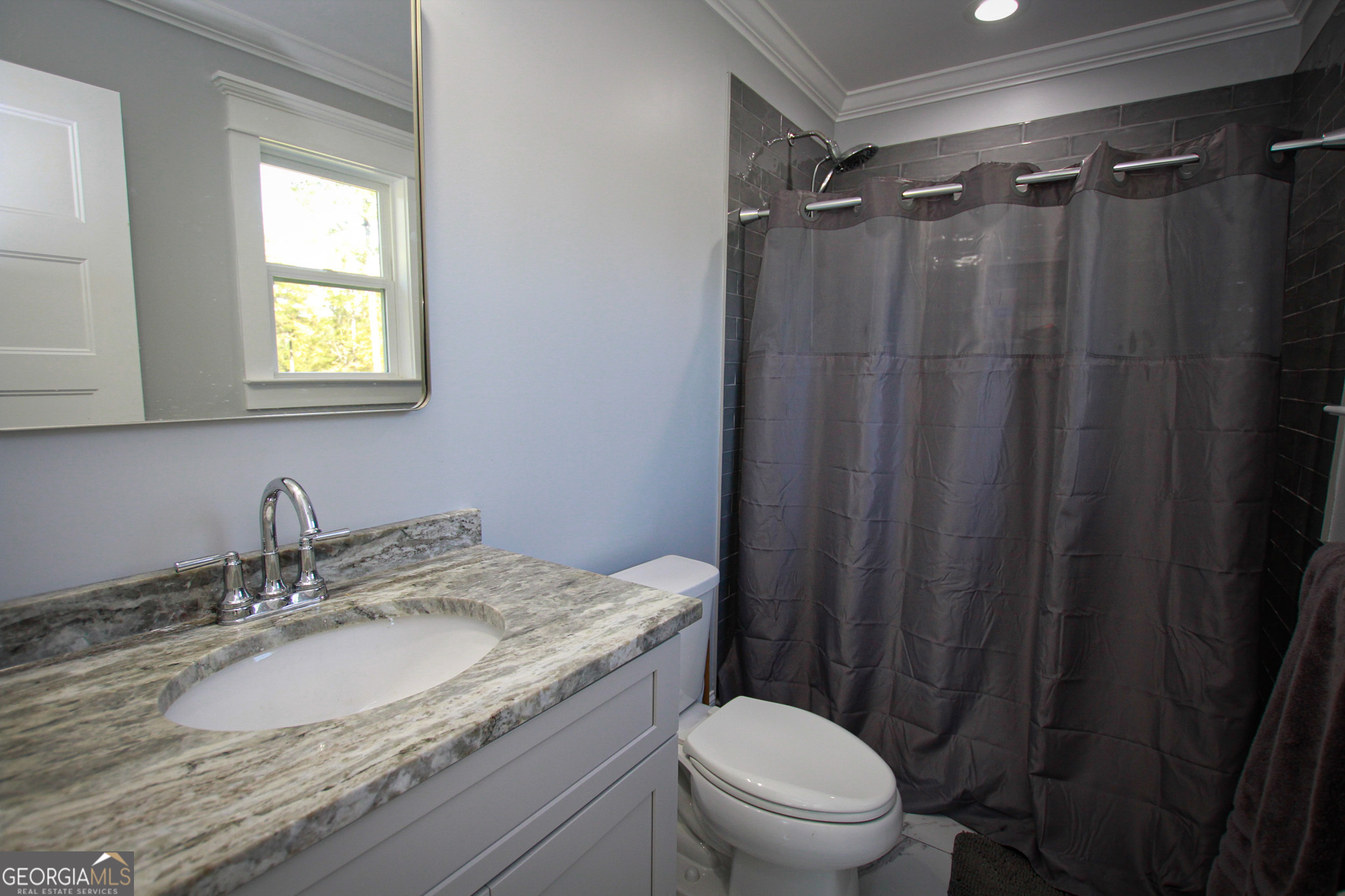 1010 Rock Road Perry, GA 31069 - Photo 40 of 58 a bathroom with a granite countertop sink toilet and shower