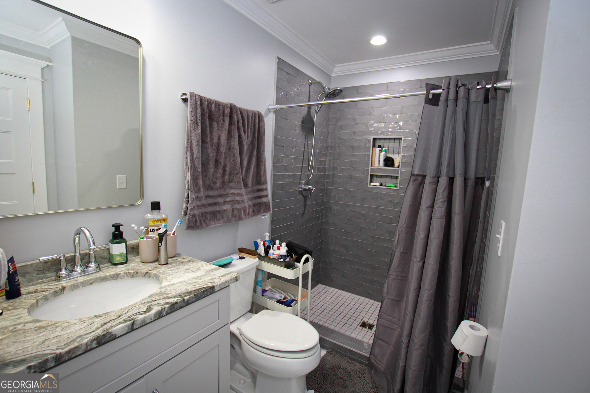 1010 Rock Road Perry, GA 31069 - Photo 42 of 58 a bathroom with a granite countertop sink toilet and shower
