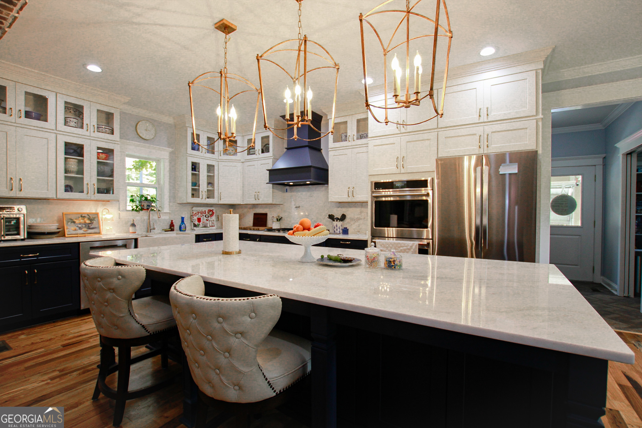 1010 Rock Road Perry, GA 31069 - Photo 9 of 58 a kitchen with stainless steel appliances granite countertop a sink dishwasher a refrigerator a stove a kitchen island and chairs with wooden floor
