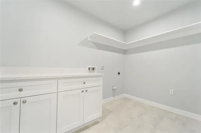 a view of storage and utility room with closet