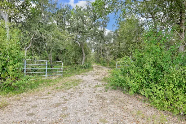 a view of a wooden fence and trees