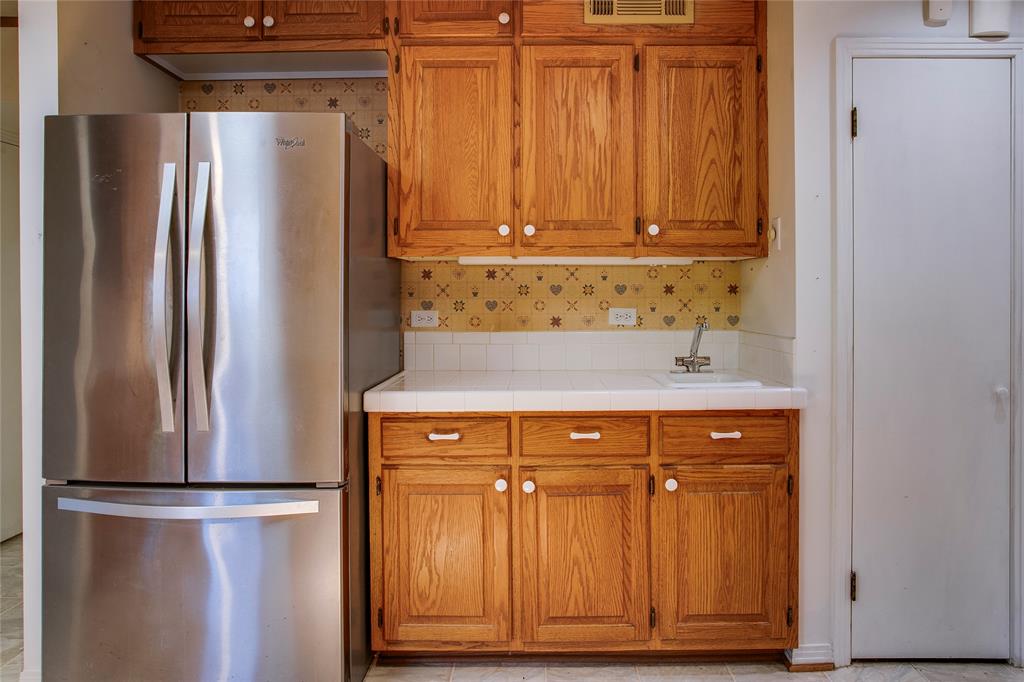 1439 Jr Drive Dallas, TX 75208 - Photo 11 of 39 a view of a refrigerator with cabinets