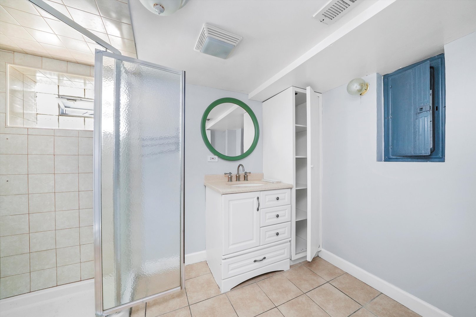 3604 West 65th Place Chicago, IL 60629 - Photo 11 of 27 a bathroom with a mirror sink and vanity