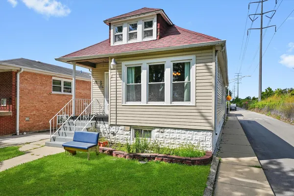 a front view of a house with a yard and table and chairs
