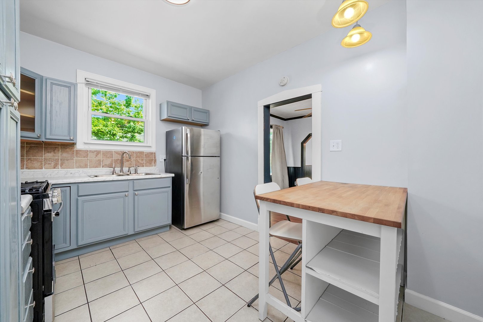 3604 West 65th Place Chicago, IL 60629 - Photo 10 of 27 a kitchen with a sink cabinets and wooden floor