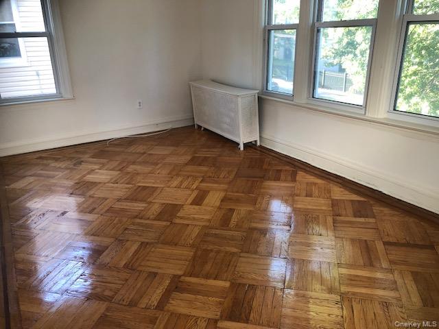 173-32 82nd Avenue Queens, NY 11432 - Photo 2 of 6 Spare room with radiator heating unit and baseboards