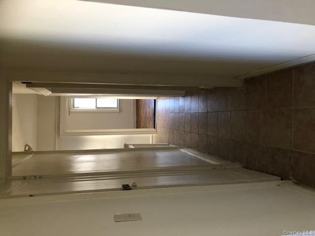 173-32 82nd Avenue Queens, NY 11432 - Photo 4 of 6 Hall with light tile patterned floors and baseboards