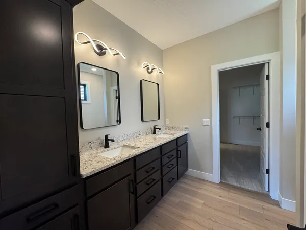 a bathroom with a double vanity sink and a mirror