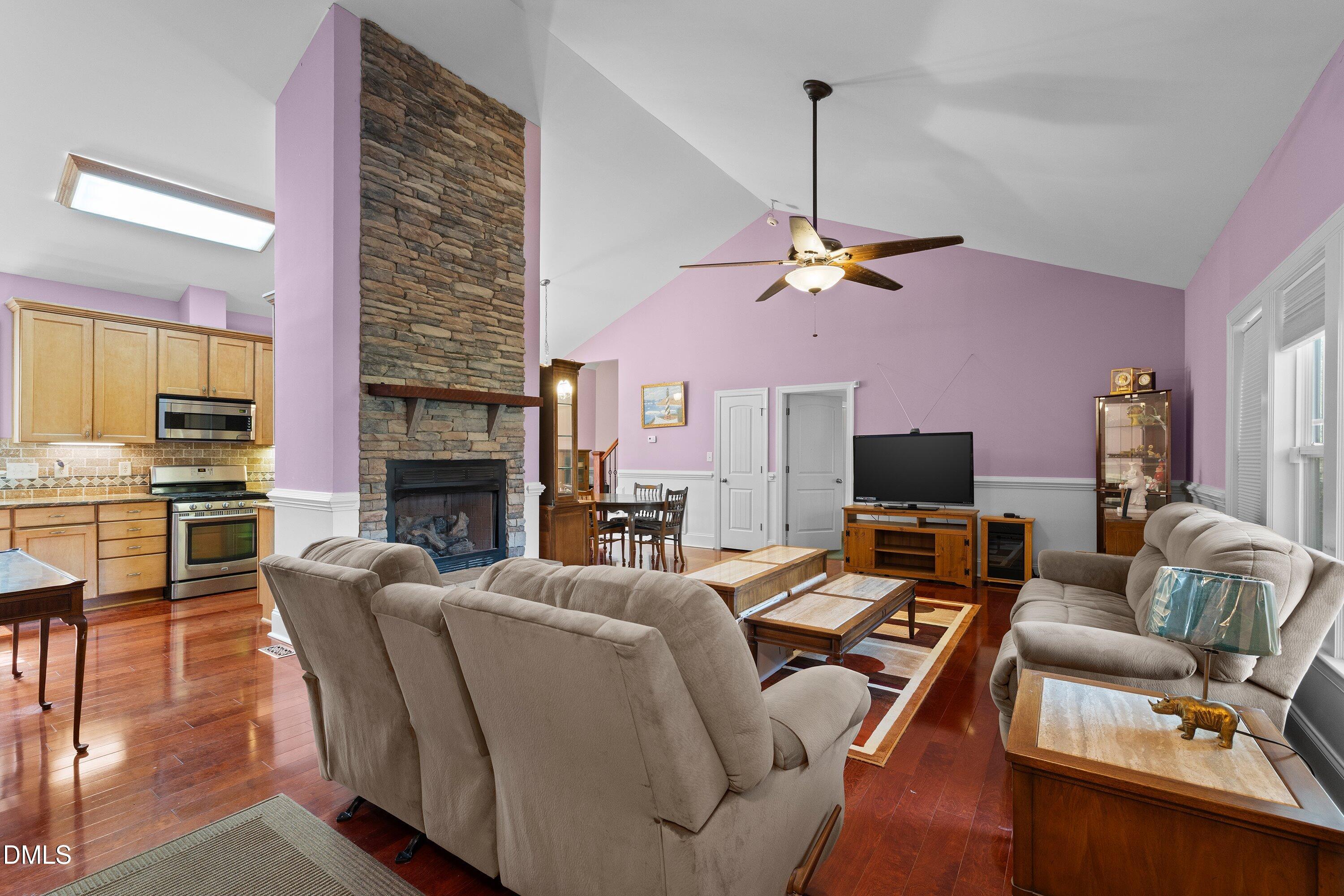 9713 Lake Wheeler Road Raleigh, NC 27603 - Photo 3 of 18 a living room with furniture a fireplace and a flat screen tv