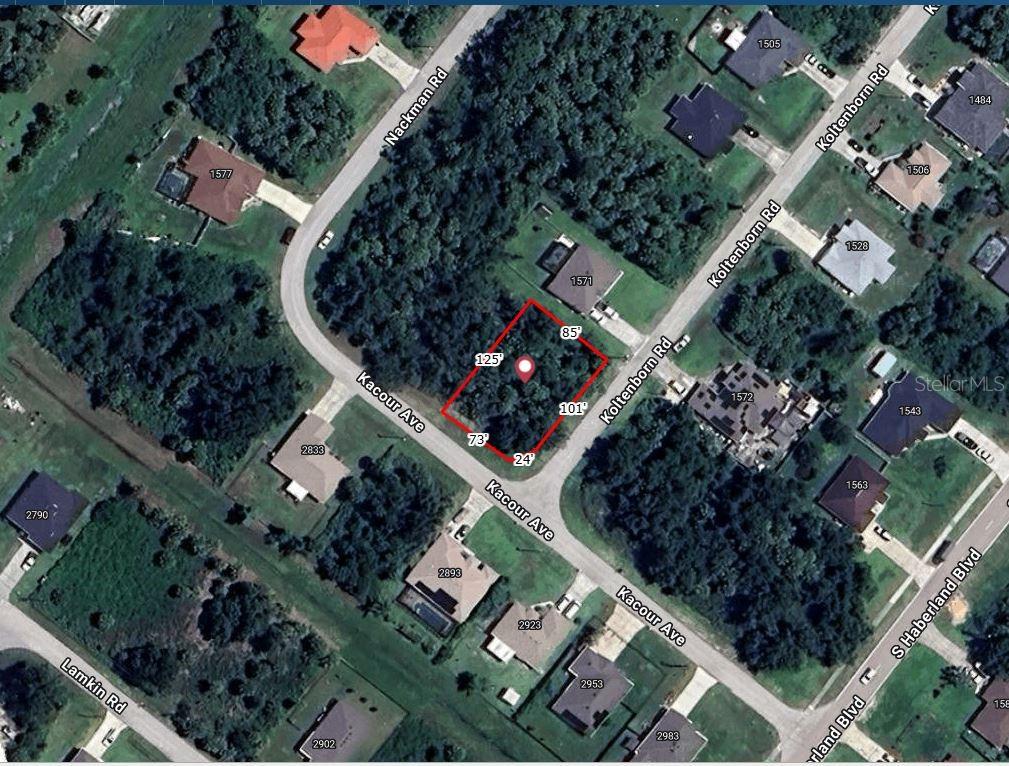 an aerial view of a residential houses with outdoor space