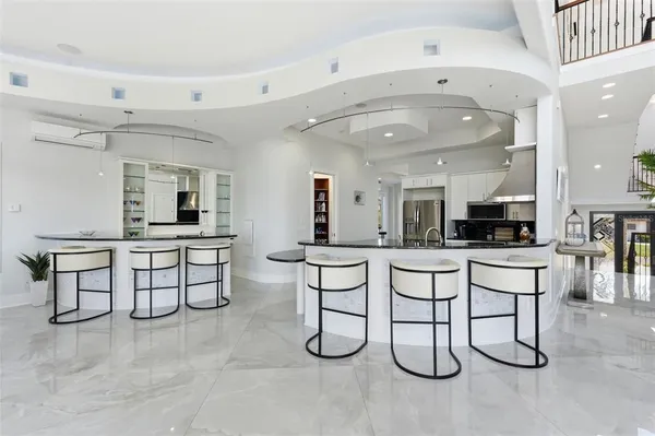 a dining room with furniture a large window and a chandelier